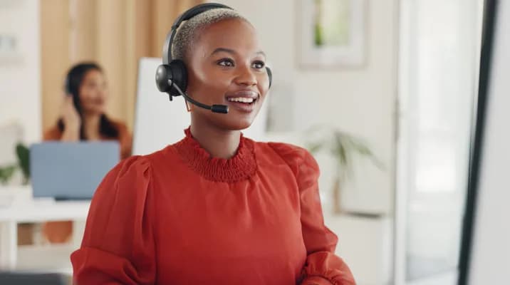 Customer service agent wearing a headset in an office